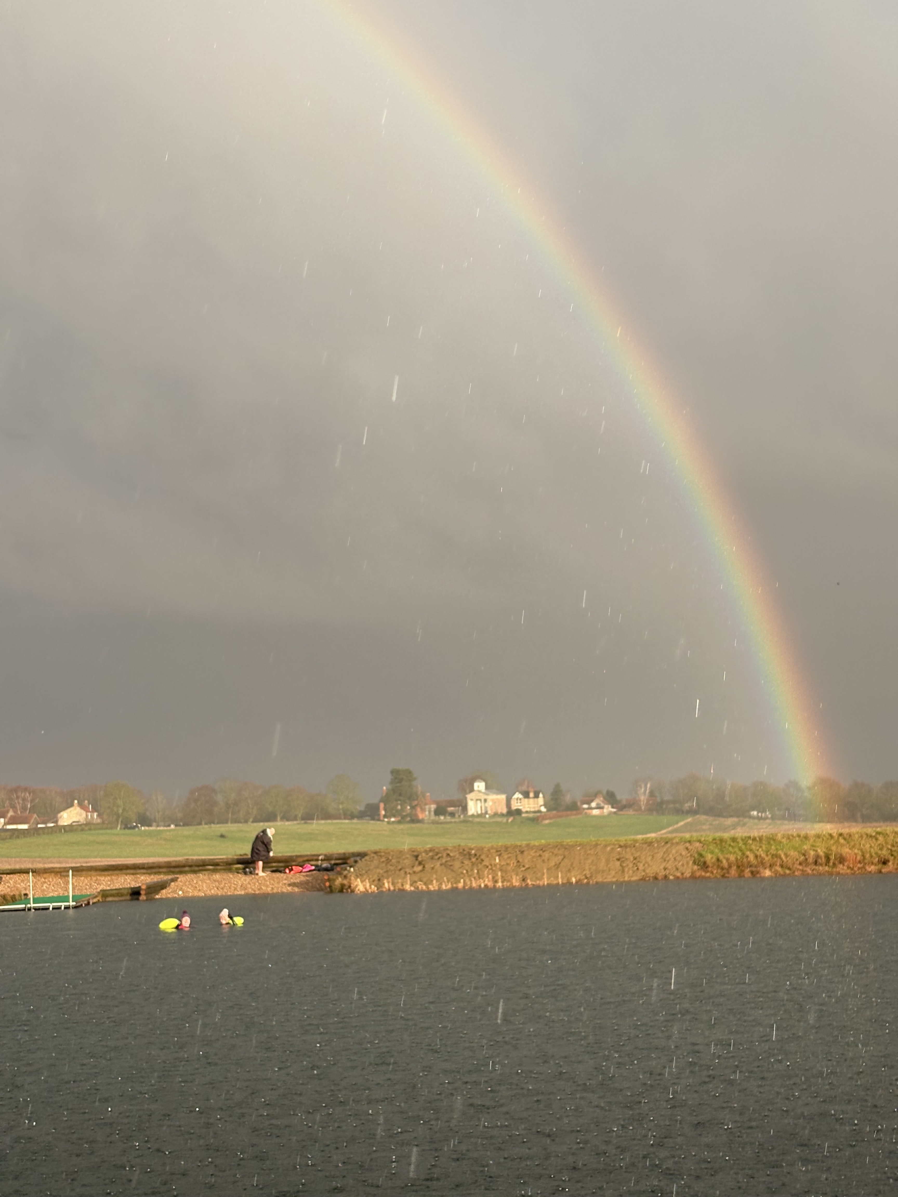 Rainbow over the reservoir and swimming community